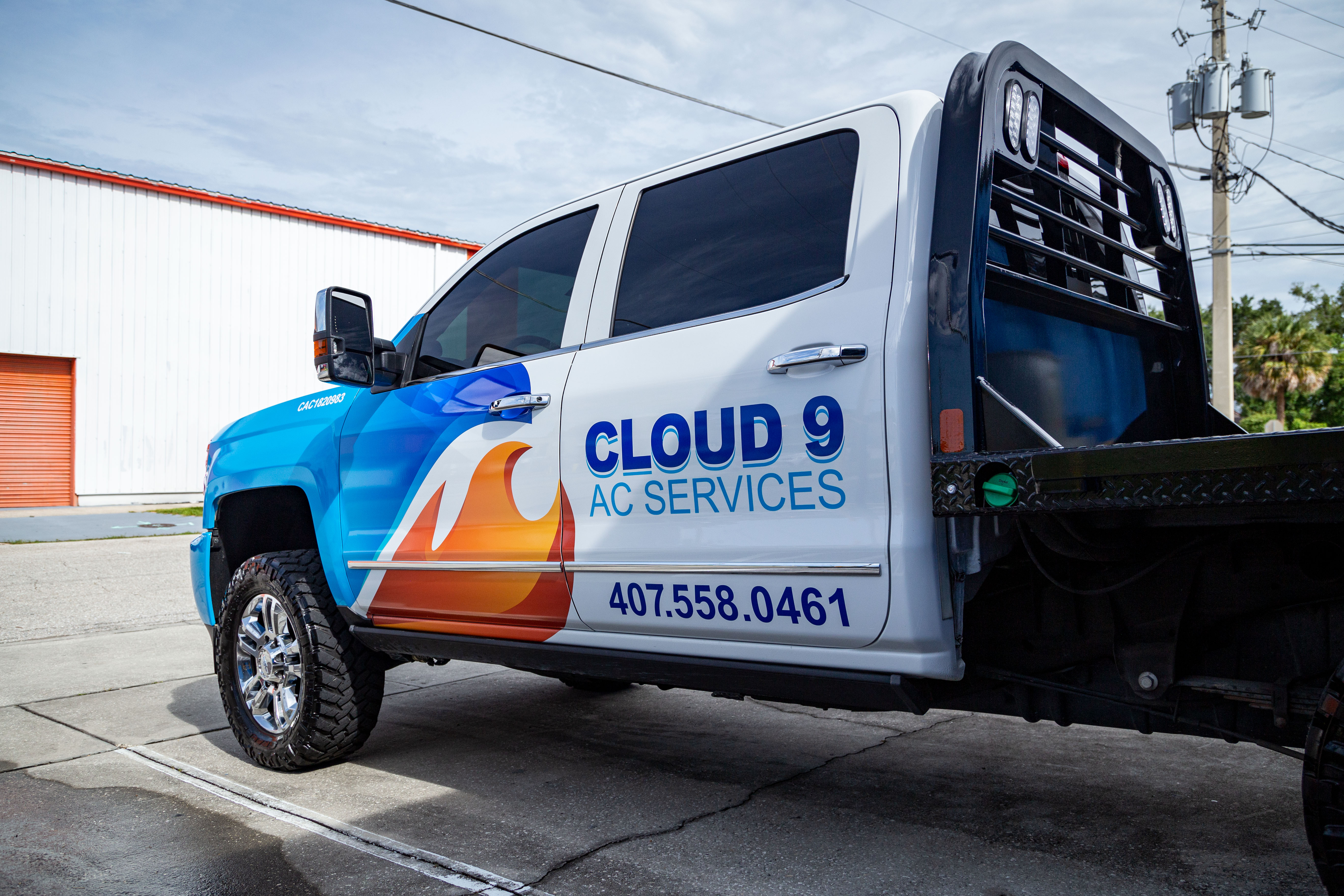 Cloud 9 Ac Services Partial Wrap on Chevy 2500 done by Hittn' Skins in Orlando, FL