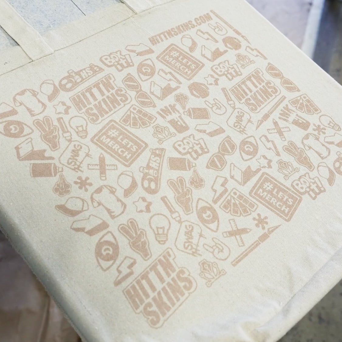 Upcycled tote bag printed with custom Hittn Skins graphics showcasing sustainable screen printing on reusable fabric
