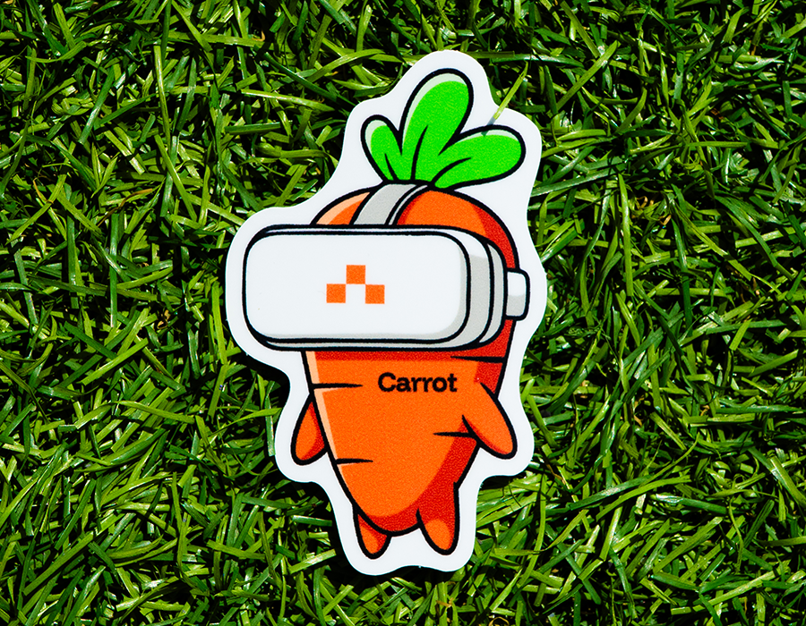 Custom die cut sticker featuring an orange carrot mascot wearing a white VR headset with bright green leaves and black illustrated outlines.