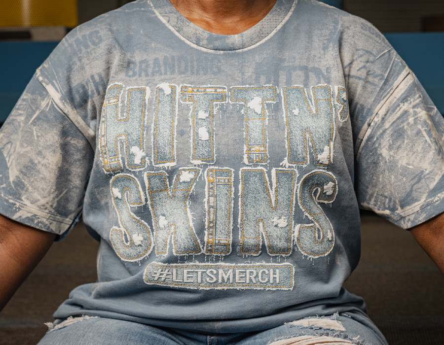 Custom blue T shirt with SFX denim effect screen printing that recreates the look and feel of distressed denim lettering.