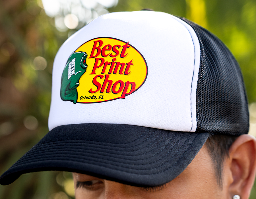 Cheap custom foam trucker hat with full-color Best Print Shop Orlando logo, mesh back and black bill for promotional giveaways.