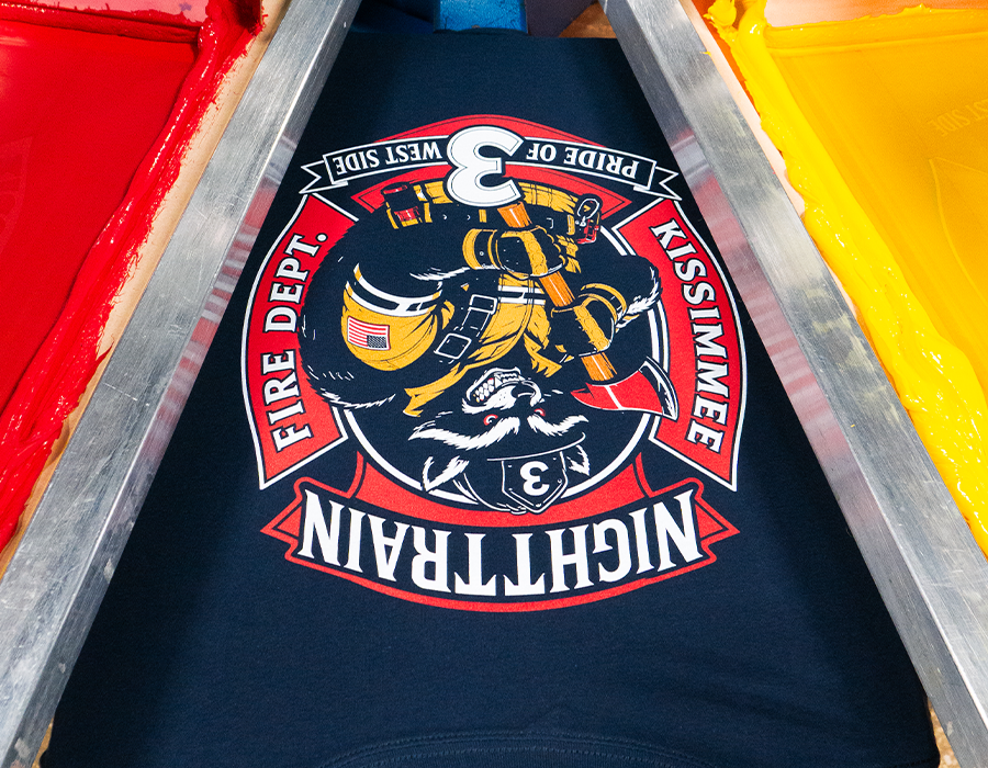 Kissimmee Fire Department custom black T shirt with detailed red, gold and white multi color screen printed firefighter artwork.