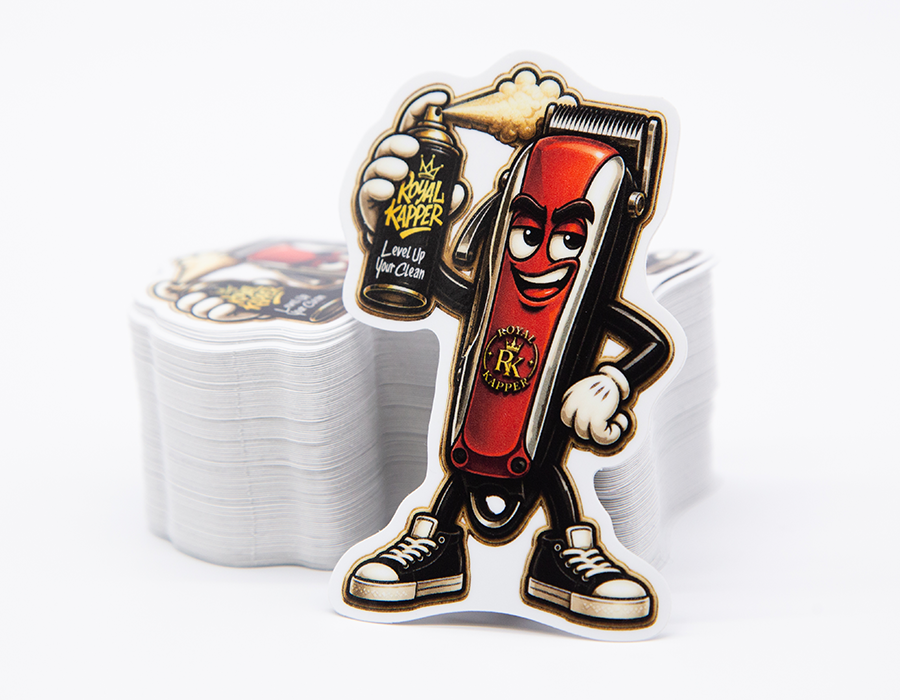 Royal Kappers custom barber shop die cut sticker featuring an illustrated red hair clipper character holding branded grooming spray.