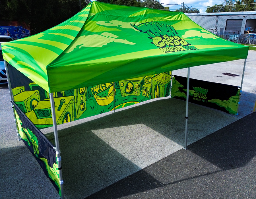 Touch Grass Music Fest custom 10x20 event tent with a full color printed canopy and branded half walls surrounding the large outdoor booth.